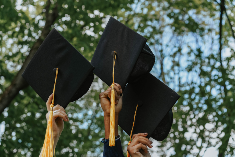 Graduation caps in the air